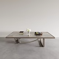 Modern Coffee Table with Marble Top and Curved Metal Base Featuring White Flowers Books and Tray