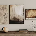 Abstract Paintings on Wall with Textured Surfaces Wooden Table Clay Vases Books and Dried Plants