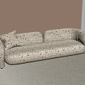 Cream Colored Two Seater Sofa With Floral Pattern And Curved Armrests In Light Room