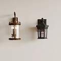 Brass And Black Wall Sconces With Glass Shades Mounted On White Wall