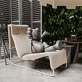 Modern Beige Chaise Lounge With Gray Sculpture Green Leafy Wall And Side Table