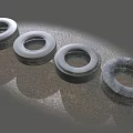 Four Old Worn Tires Placed On Gray Rough Ground Surface 3d model