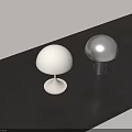 Mushroom Shaped Table Lamps White And Silver With Round Cylindrical Bases On Dark Wooden Tabletop