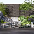 Natural Rockery Stones With Waterfall Green Plants Tree And Wooden Deck By Background Wall