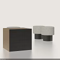 Three Elegant Plush Stools with Dark Cylindrical Legs Against Light Background