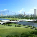 Scenic Bridge Spanning River With Green Grass Trees Vehicles And City Skyline