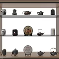 Traditional Tea Sets Display On Wooden Shelves With Various Teapots And Tea Cakes