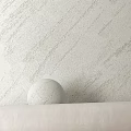 Textured White Wall With Round Sphere Decor In Minimalist Interior