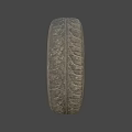 Worn Car Tire With Deep Tread And Rusty Metal Rim On Gray Background