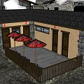 Traditional Cottage Featuring Stone Walls Wooden Roof And Red Umbrellas On Wooden Terrace