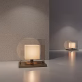 Square Table Lamp With White Lampshade Dark Base On Light Colored Tabletop Gray Wall