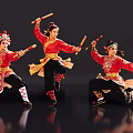 Group of Traditional Dancers Performing with Long Sticks in Red Costumes