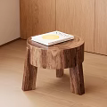 Natural Wooden Round Side Table With Three Legs And Magazine On Top