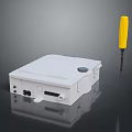 White Electrical Enclosure With Yellow Screwdriver And Connection Ports On Reflective Surface