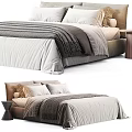 Modern Double Bed Setup With Neutral Tones Bedding Knitted Blanket Pillows And Nightstand