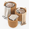 Three Woven Storage Baskets With Folded Clothes And Towels For Home Organization
