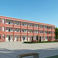 Red Brick Multi Story School Building With Windows Balconies Front Square And Green Trees