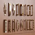 Collection Of Decorative Brass Cabinet Handles With Various Designs On Wooden Surface