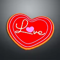 Heart Shaped Red Cookie Decorated With Love Lettering And Pink Heart