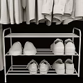 Organized Clothes Hanging On Hangers With Shirts Pants And Shoes Below