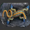 Colorful Painted Lizard Sculpture With Vibrant Patterns On Rock Base