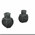 Two Black Hexagonal Jars With Intricate Carved Patterns On White Background