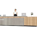 Modern Wooden Reception Desk with Tablet Electronic Devices and Flower Vase and Receptionist Standing Behind