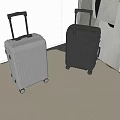 Modern Silver And Black Suitcases With Telescopic Handle And Rolling Wheels In Indoor Space