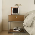 Modern Nightstand with Metal Frame Brown Drawer Table Lamp Picture Frame Books and Decor