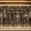 Elegant Wine Cellar With Stone Wall And Hanging Wine Bottles Illuminated By Warm Lighting