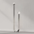 Modern Minimalist Floor Lamp With Sleek Metal Frame And Glass Base Against Neutral Wall