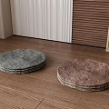 Round Woven Floor Cushions in Gray and Brown on Wooden Floor with Plant Pot
