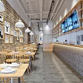 Modern Restaurant Interior With Wooden Tables Chairs Brick Walls Pendant Lights And TV Screens