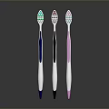 Three Different Colored Toothbrushes With White Brush Heads And Colored Bristles For Daily Use