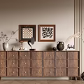 Wooden Brown Chest of Drawers with Framed Artworks Vase and Decorative Items in Minimalist Room