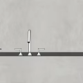 Stylish Faucets with Different Finishes on Light Gray Countertop and Beige Wall