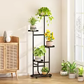 Multi Tiered Black Plant Stand With Green Plants And Yellow Flowers For Indoor Home Decor