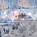Elegant Banquet Hall With Floral Decorations Hanging Installations And White Chairs