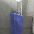 Blue Mop with Silver Handle and Gray Tiled Wall Background for Daily Cleaning