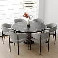 Round Black Marble Dining Table Set With Six Gray Chairs And Orange Flower Vase