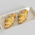 Two Fresh Baked Croissants With Sesame Seeds On White Rectangular Tray