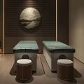 Two Green Massage Beds With Small Stools And Circular Wall Art In Modern Spa Room