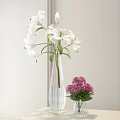 White Lilies in Transparent Striped Vase with Pink Chrysanthemums in Small Green Vase