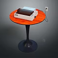 Round Wooden Table With Orange Top Black Metal Leg And White Appliance