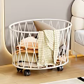 Bedroom with White Round Rolling Storage Basket Folded Blankets Clothes Beige Bed Light Colored Walls