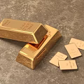 Precious Pure Gold Jewelry Featuring Shiny Gold Bars And Small Gold Pieces On Textured Surface
