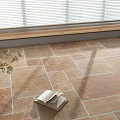 Warm Toned Natural Texture Floor Tiles With Open Book Potted Plant And Sunlight Shadows