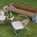 Outdoor Wicker Chairs With White Cushions Bench And Small Round Table On Green Lawn