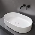 White Oval Countertop Washbasin with Black Faucet on Grey Bathroom Countertop