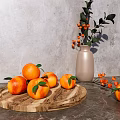 Fresh Oranges on Wooden Tray with Gray Countertop and Vase with Orange Berries